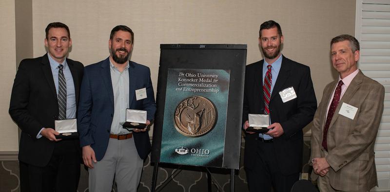 From left, alumni Adam Wachter, Michael Davis and Brian Davis with Interim Vice President of Research and Creative Activity David Koonce at the Inventors Dinner.