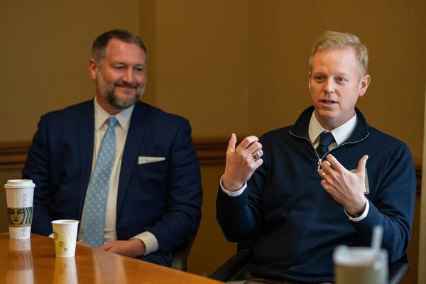 Alumnus John Rubis '21, right, talks with Ohio University students about corporate law.