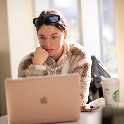 An OHIO student works on a laptop computer