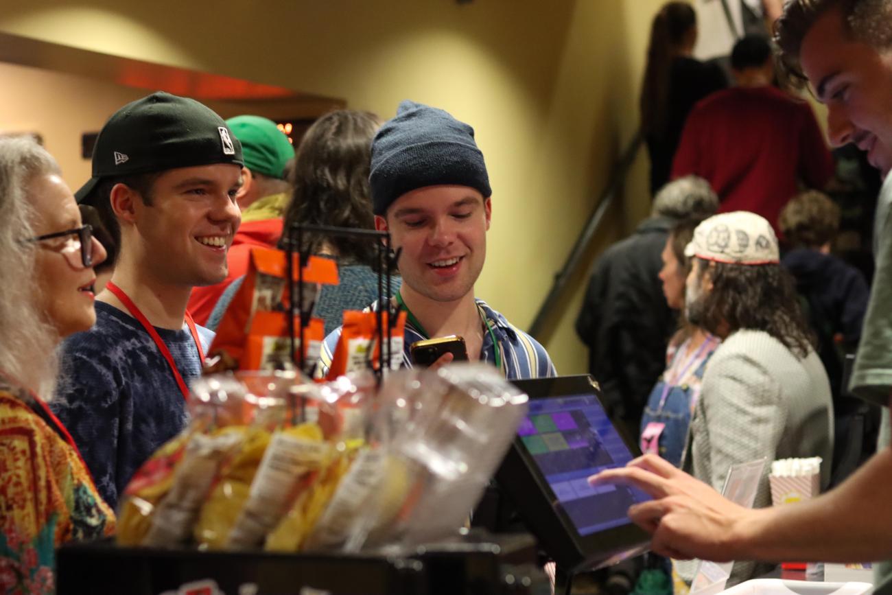 AIFVF attendees wait in the concession line in the Athena Cinema lobby.