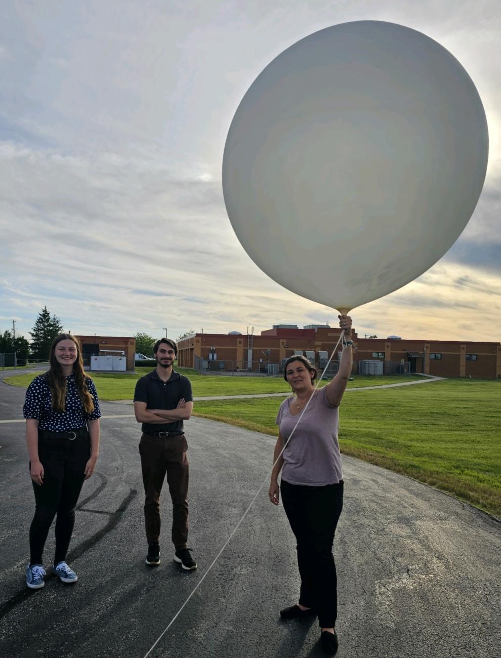 Student volunteer holds balloon