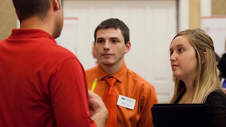 Accounting students meet with an accounting professional during a networking event.