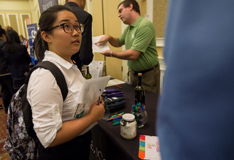 An accounting student speaks with an industry professional at a School of Accountancy networking event.