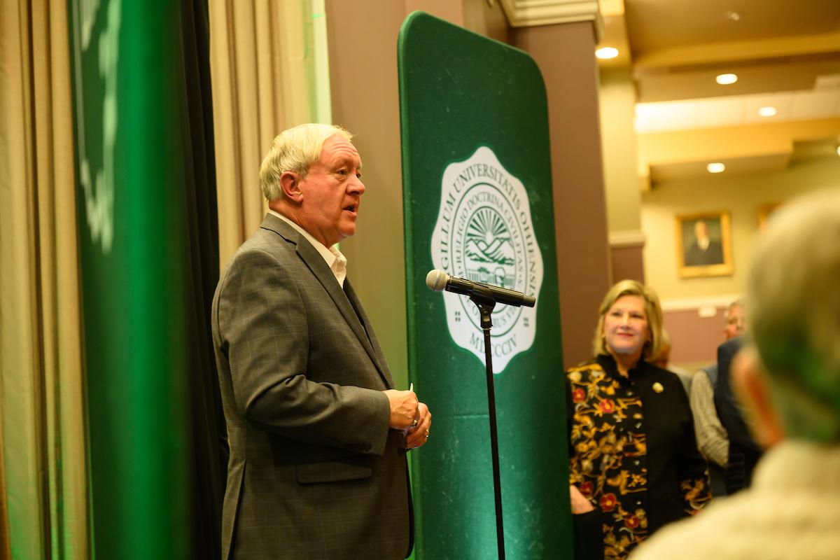 M. Duane Nellis speaks while President Lori Stewart Gonzalez looks on during the retirement ceremony