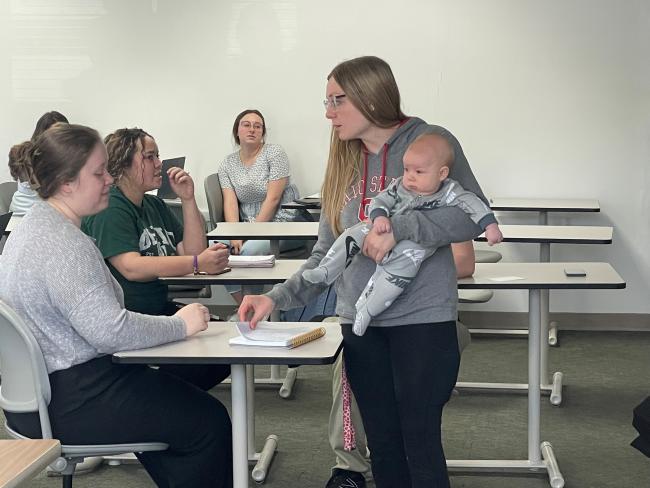 Student Social Work Association President Lauryn Miller talks with other social work students at Ohio University Chillicothe