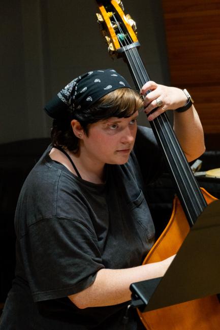 Adeline Collins plays the bass in the orchestra.