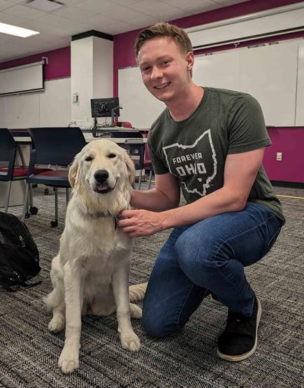 Ohio University senior Griffin Foltz ’24 with a furry friend