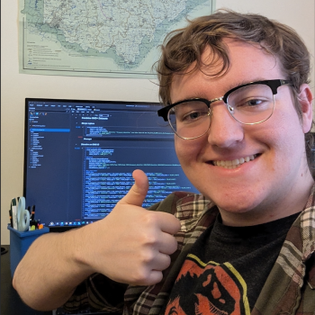 Intern poses with thumbs up