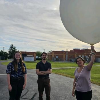 Student volunteer holds balloon