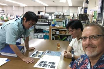 Group looking at pictures and documents on tables