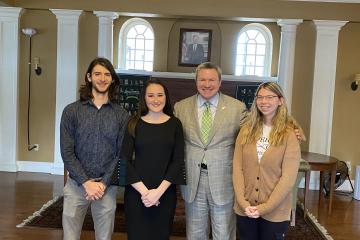 Students Eli Wanner, Katy Perani and Kate Fedderson pose with Chancellor Mike Duffey