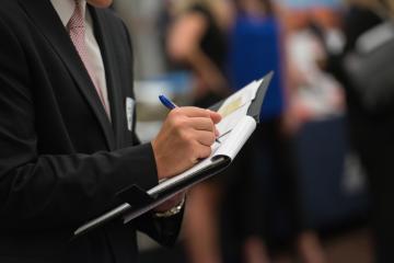 Student taking notes at career fair