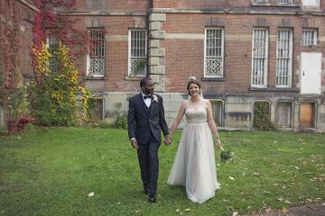 OHIO graduates Russell Morrow and Kasey Daniel are pictured on their October 2016 wedding day outside a building at The Ridges in Athens.