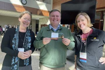 Larry Hayman, center, getting the MAPLA gavel at University of St. Thomas Law School in Minneapolis, with Martha Kirby, Immediate Past President, University of Iowa, right, and Erin Reichelt, President-Elect, University of Minnesota, left.