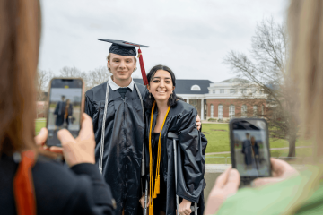 Graduates pose for photos following Fall Commencement.