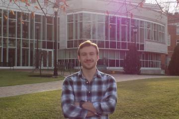 Gavin Wallace  is shown in front of Patton Hall