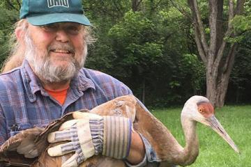 Scott Moody with a Sandhill Crane in 2017.