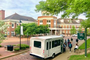 An OHIO Shuttle picks up passengers outside of the Baker University Center