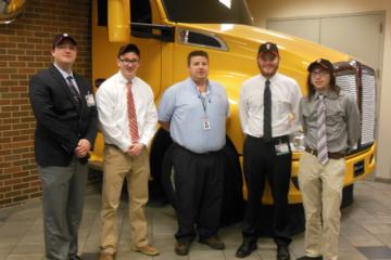 ISE students stand at Kenworth for their final presentation