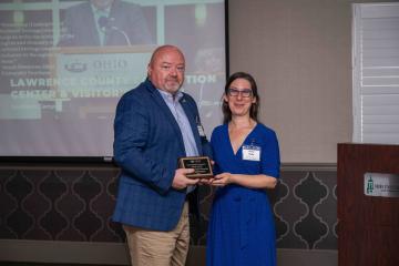 Marty Conley accepting plaque honoring partnership