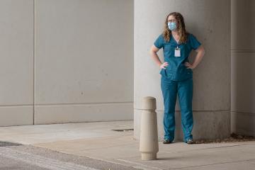 Women standing in scrubs outside of a building