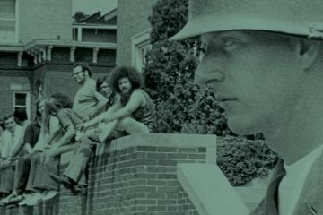 Students sitting a wall with soldier in the foreground