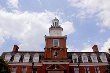 Ohio University's Stocker Center is bordered by a blue sky with clouds.