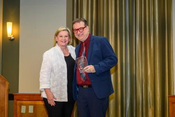 President Lori Stewart Gonzalez and Kevin Cordi are shown with the award Kevin Cordi received at the Faculty Awards and Recognition event