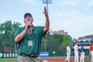 Dean Scott Titsworth waves to the crowd at the Southern Ohio Copperheads baseball game