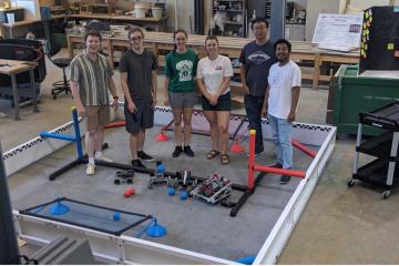 A group of people pose for a picture standing in a lab