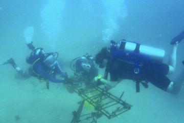 Student scuba dives underwater for internship research