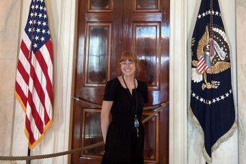 Ava Hamilton stands next to flags at the Appalachian Regional Commission office in Washington, D.C.