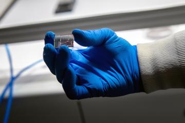 OHIO Professor Savas Kaya holds a semiconductor.