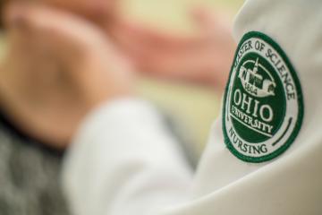 Closeup of a the badge of an Ohio University nursing student.