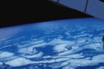 An image of a satellite in orbit, with the Earth in the background