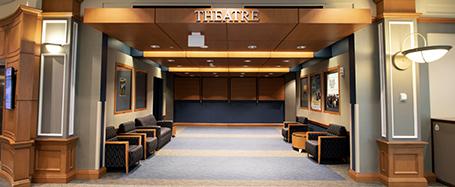 The lounge outside of the theater, featuring several armchairs and open space