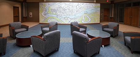 The lounge outside of the theater, featuring several armchairs and open space