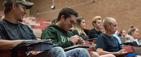 three students take notes in morton