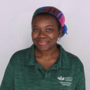 Roxanne in a dark green Bobcat Student Orientation shirt, smiling at the camera.