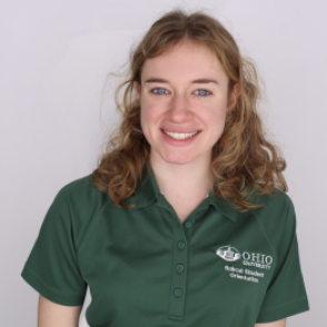 Casidy in a dark green Bobcat Student Orientation shirt, smiling at the camera.