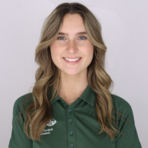 Eva in a dark green Bobcat Student Orientation shirt, smiling at the camera.