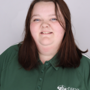 Mckenzie in a dark green Bobcat Student Orientation shirt, smiling at the camera.