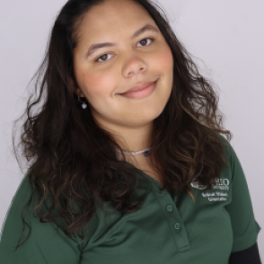 Cassie in a dark green Bobcat Student Orientation shirt, smiling at the camera.