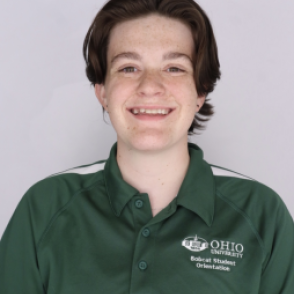 Avrin in a dark green Bobcat Student Orientation shirt, smiling at the camera.