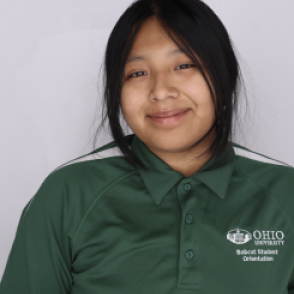 Yanett in a dark green Bobcat Student Orientation shirt, smiling at the camera.