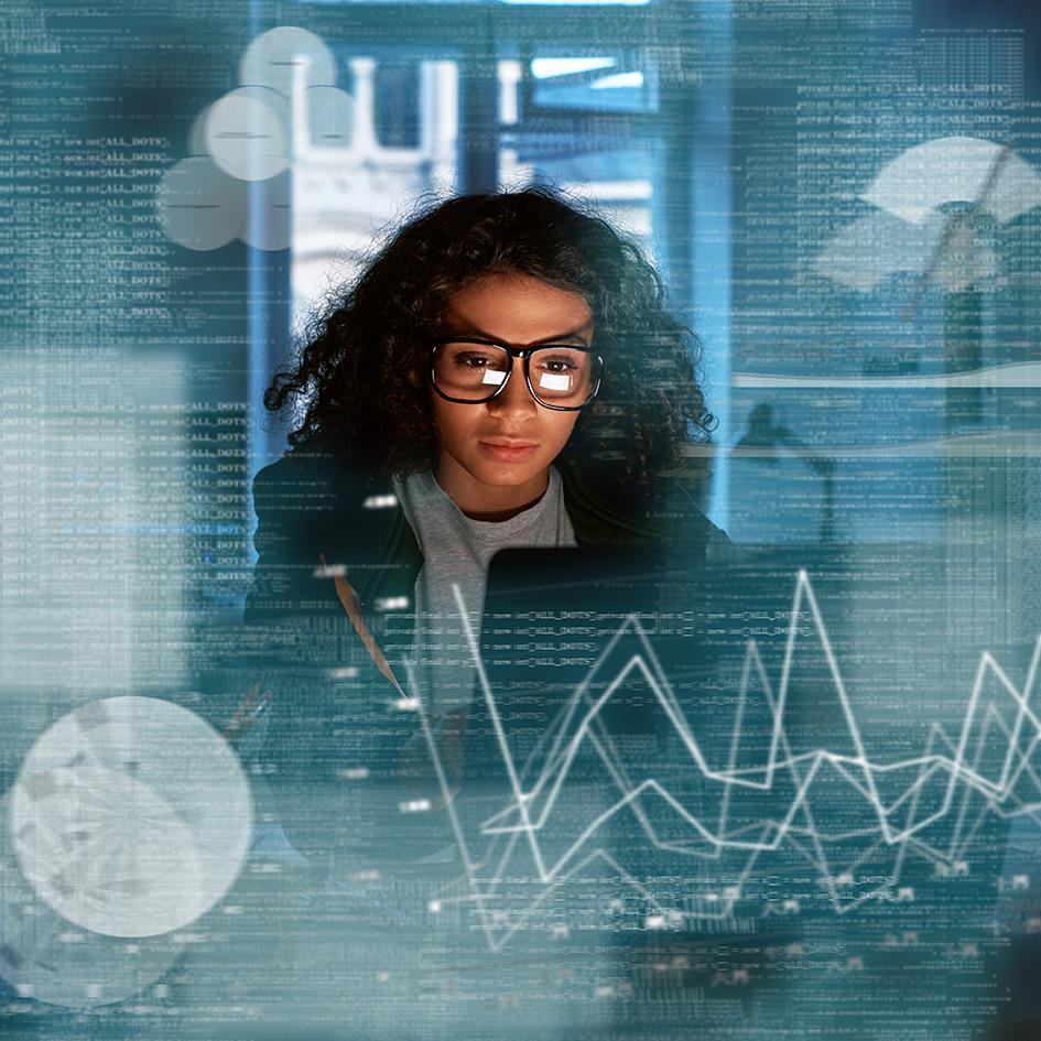 Woman looking at computer with graphs superimposed