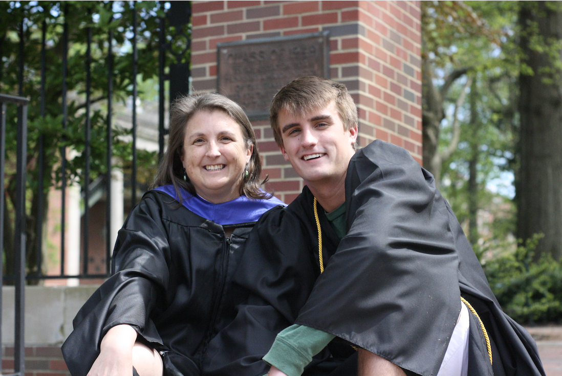 Jennifer Whetstone and her son Zachary pose in graduation robes.