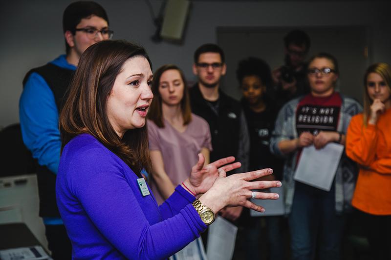 Jessica Collura talking in front of a meeting