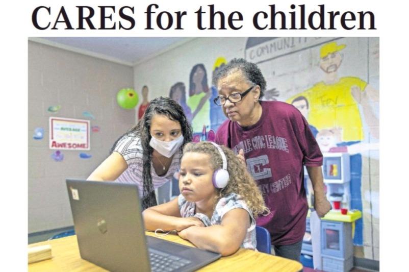 A screenshot of the cover the Columbus Dispatch article. Two women help a child with online schooling.