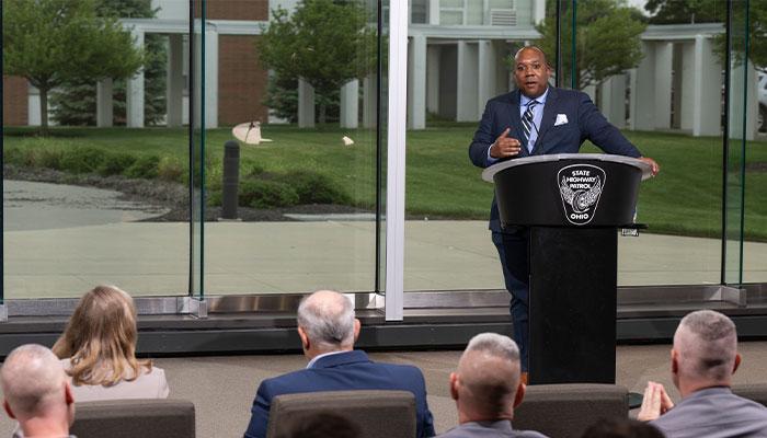 Ohio MPA Graduate, Gary Allen, at podium speaking to gathering for Ohio State Highway Patrol